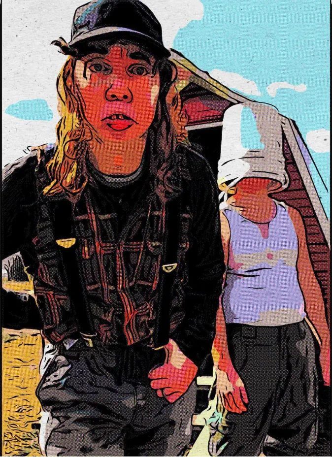 Buzz in plaid and suspenders standing in front of a red barn, with Butch behind him